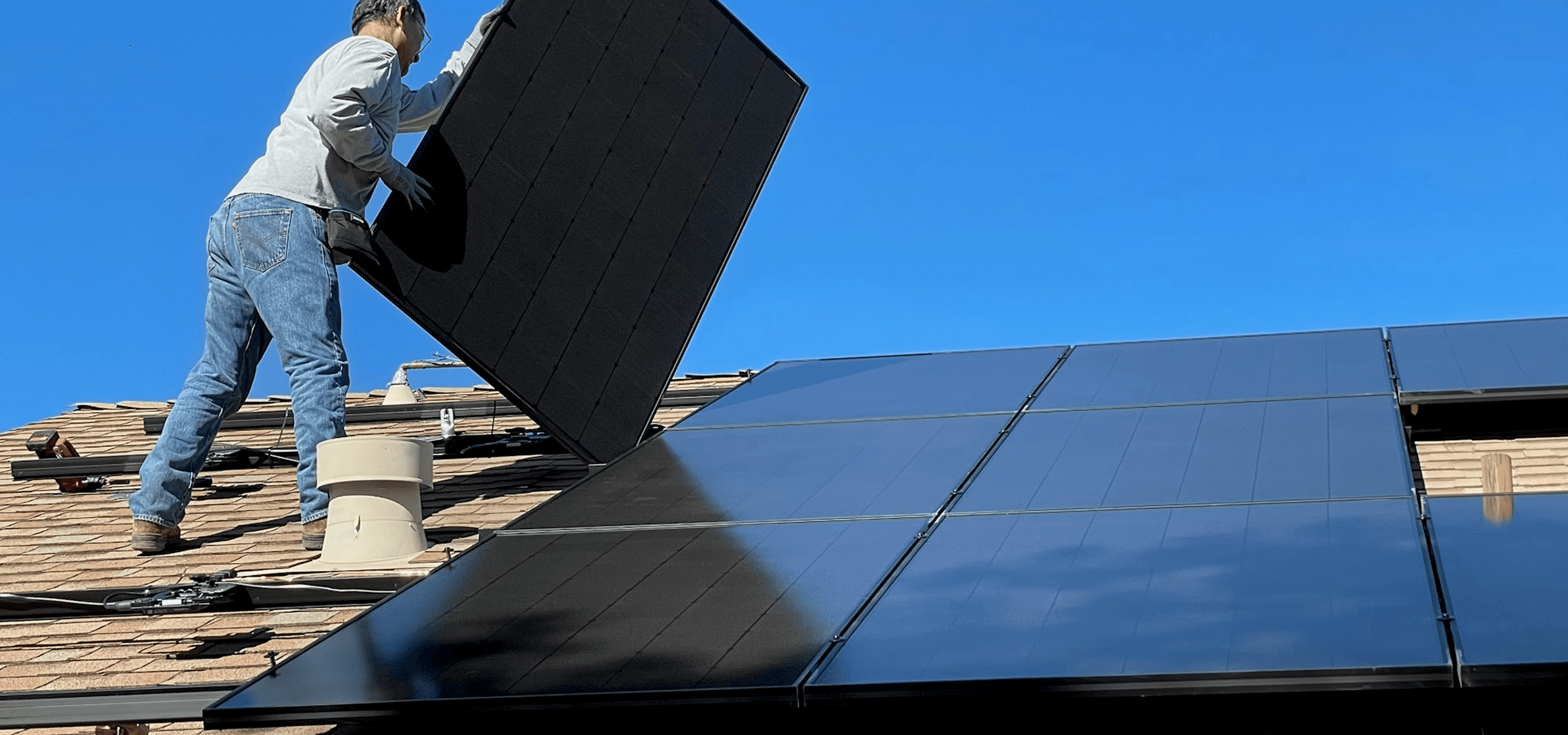 Golden retriever dog sitting near solar panels and camper
