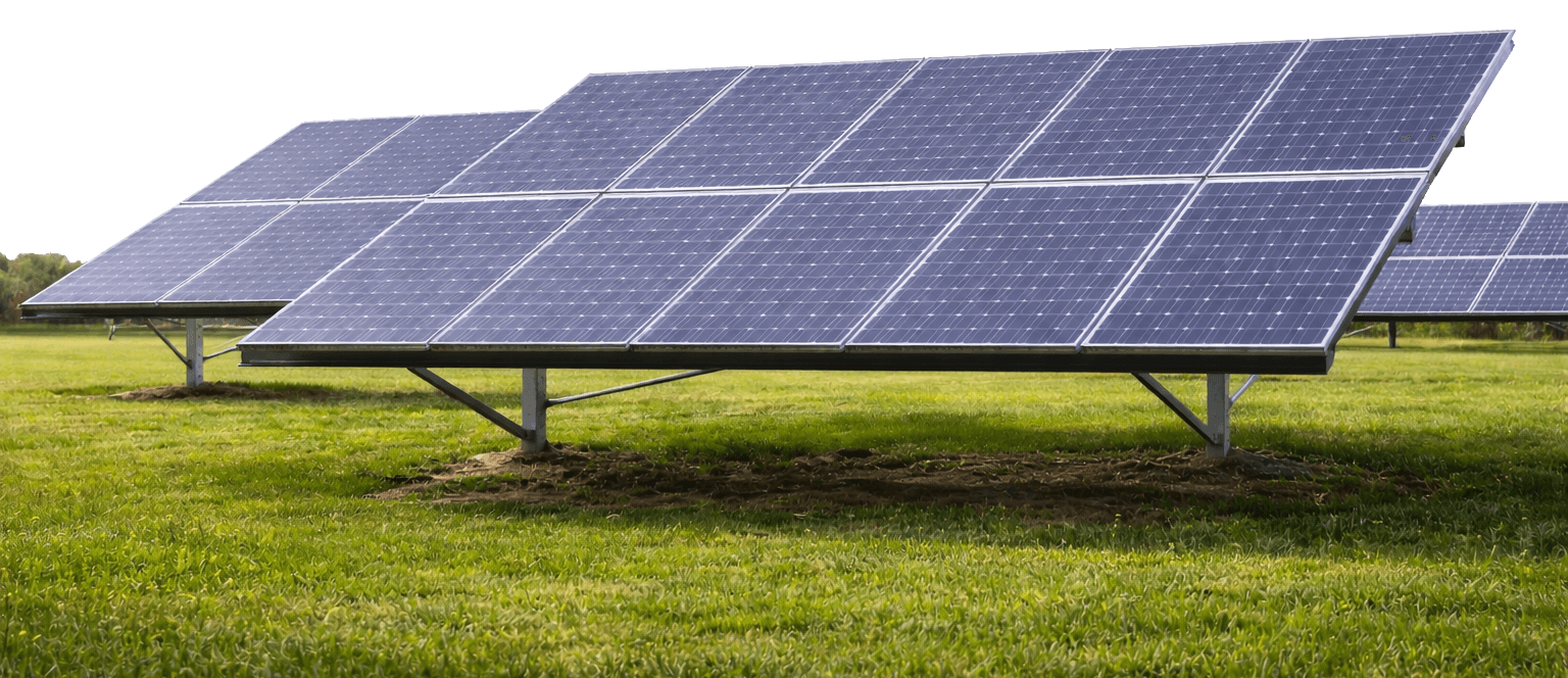 Solar panels on a grassy field under a clear sky.